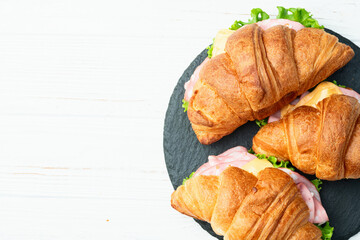 Croissant sandwich with salad ham and cheese . Top view