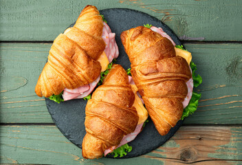 Croissant sandwich with salad ham and cheese . Top view