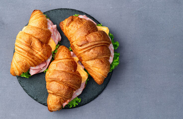Croissant sandwich with salad ham and cheese . Top view