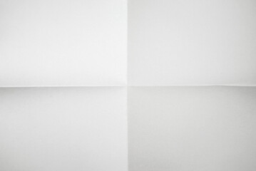 A4 sheet of white paper folded. White paper folded on a background of four fractions