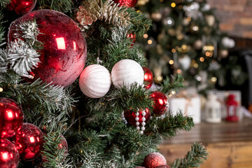 Christmas decorations, toys. Hygge New Years concept. Closeup of decorated fir branches with red, white and silver baubles, Winter holidays.