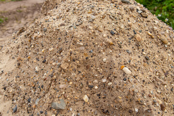 Sand and gravel mixture. Material for land works. Sand with stones