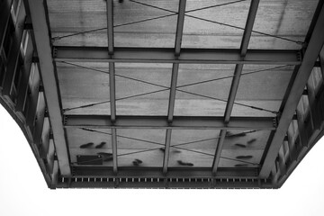 black and white image of a metal ceiling structure