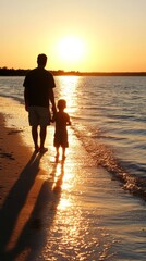 Fototapeta premium A silhouette of a parent and child walking along the beach at sunset.