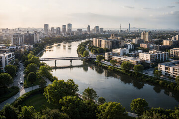 Aerial View of Modern City Skyline at Sunset with Skyscrapers, River, and Bridge