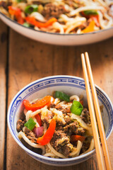 Asian stir fry with spicy beef, noodles, red pepper, cabbage, red onion 