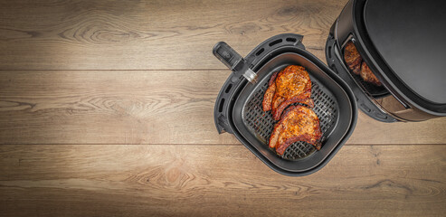 Fresh delicious steaks prepared in airfryer no fat by circulating hot air inside the basket. Long...