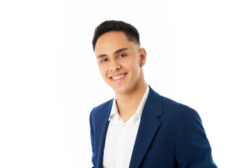 A young man in a blue suit and white shirt is smiling for the camera