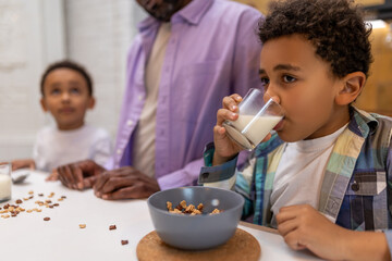 Father and kids having breakfast together in the kitchen