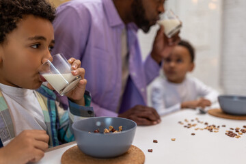 Father and kids having breakfast together in the kitchen