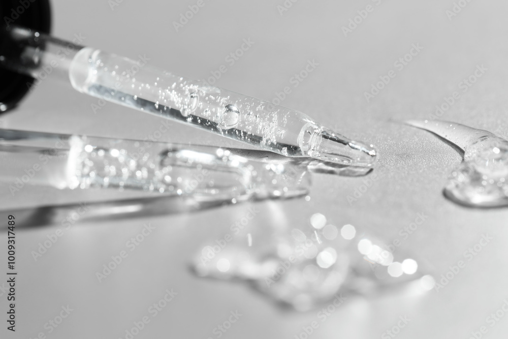 Sticker Cosmetic serum and pipettes on grey background, closeup