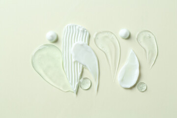 Smears of different cosmetic products on white background, flat lay