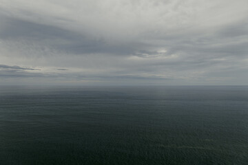 Raining sky over the Atlantic Ocean, Tenerife. Minimalism. Misty morning in the sea. Calm view. Tranquil empty landscape with soft blue gray sky. Natural gloomy weather.