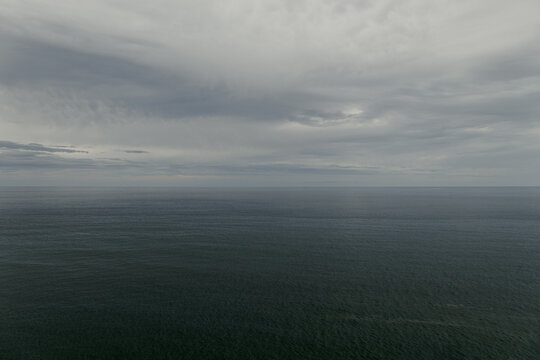Raining sky over the Atlantic Ocean, Tenerife. Minimalism. Misty morning in the sea. Calm view. Tranquil empty landscape with soft blue gray sky. Natural gloomy weather.