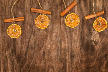 Christmas pendant with dried orange and cinnamon. Wooden background
