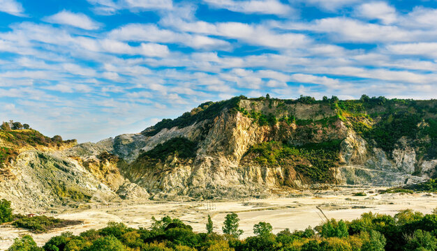 landscape of Plegrean volcano fields in Naples Italy near Pompeii with sulfur yellow caldera duribg eruption of smoke. campi Flegrei and cataclysm of Earthquake