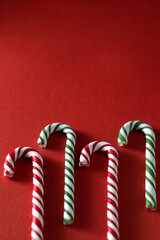 Christmas red background. Сandy cane Lollipops, copy space