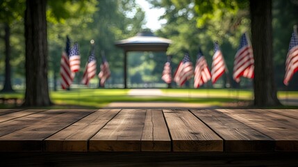 Wooden table with a peaceful park in the background, filled with American flags and sunny skies