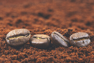 Coffee beans on ground coffee background