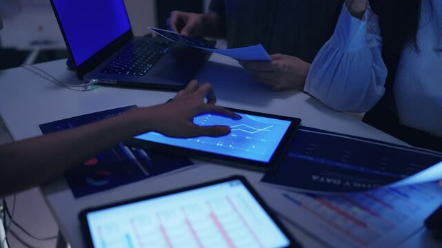 close up hand team of financial discussion fintech technology planning, analyzing digital financial data and strategy in a modern office at night