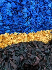 Woven scrim in the colors of the national flag of Ukraine. Blue and yellow colours. And military camouflage scrim. Close up detail