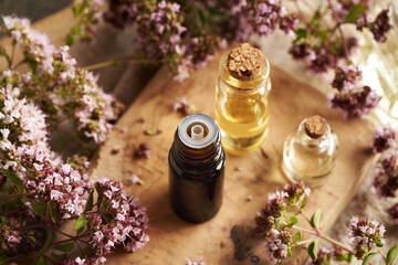 A bottle of oregano essential oil on a wooden table