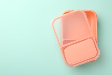 One empty lunch box on light blue background, top view. Space for text