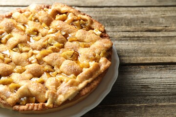 Homemade apple pie on wooden table, closeup