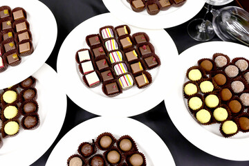 Colored handmade chocolate candies on a plate.