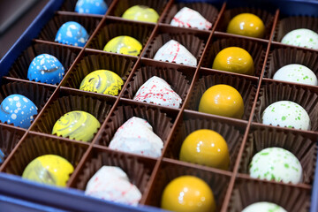 Close up of different assortments of handmade colored chocolate candies.