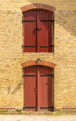 Yello brick wall with read blindes 