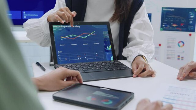 close up hand team of financial discussion fintech technology planning, analyzing digital financial data and strategy in a modern office