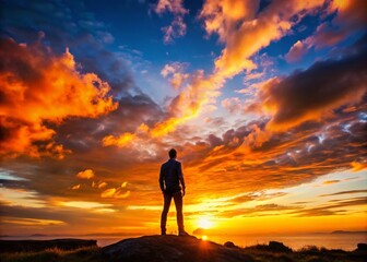 Silhouette of a Human Figure Against a Vibrant Sunset Background in a Calm Natural Environment