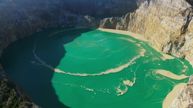 Aerial view of volcano Kelimutu with tricolored lakes in Flores