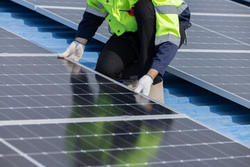 Engineer checking on solar panel on the factory rooftop
