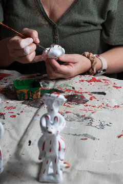 The hands of a craftswoman elaborating a traditional and ancestral figure of clay craftsmanship in Mallorca (Spain) called "siurell".