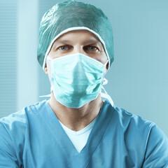 Surgeon wearing surgical mask standing in hospital
