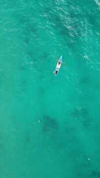 Vertical Video - Aerial Capture of Tourists Kayaking on Ocean Waters