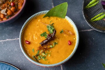 Classic Indian chicken dal curry with dry chili, coriander, and Pomegranate