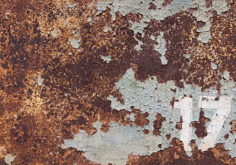 A rusted metal background with the number 17 in the lower right corner