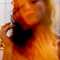seductive young sexy woman bathed in warm, golden light, dreamy and introspective expression