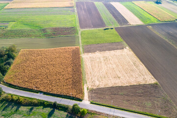Aerial view of diverse agricultural fields, showcasing various crop patterns and colors. Ideal for...