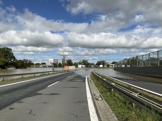 Fototapeta premium Flooded and impassable national road DK1 due to pool of water at confluence of Rivers Wapienica and Iłownica during flood in September 2024 in Poland in Czechowice Dziedzice. Topic: river alert status