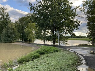 Flooded fields and asphalt roads along the Iłownica River during flood in September 2024 in Poland in Czechowice Dziedzice. Topics: natural disaster, river alert status, natural environment