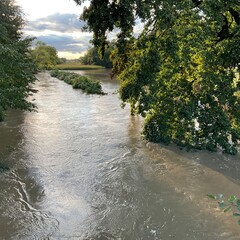 Pool of water, flooded fields and trees along the Iłownica River during flood in September 2024 in Poland in Czechowice - Dziedzice. View from bridge on river. Topics: natural disaster, river alert