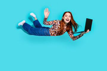 Full size photo of attractive young woman flying wave hand hold netbook dressed stylish colorful...