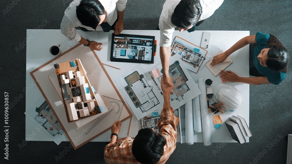 Poster top view of skilled architect engineer working together and shaking hand cooperative team while maki