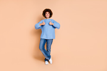 Full size photo of optimistic cheerful nice girl dressed knit sweater jeans showing thumbs up good job isolated on pastel color background