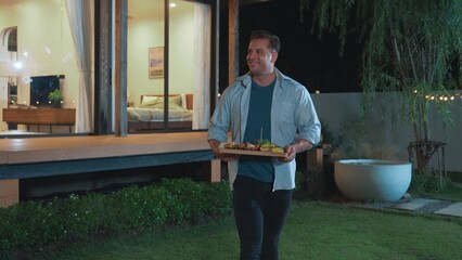 Family gather celebrate holiday, Focus father carry food to serve family member. Outdoor camping...