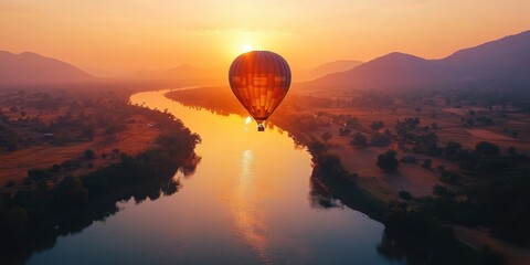 a hot air balloon flying over a river